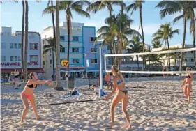  ?? AP PHOTO/MARTA LAVANDIER ?? On Feb. 27, a group plays beach volleyball along Ocean Drive in Miami Beach, Fla.