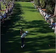  ?? DAVID J. PHILLIP / AP ?? Scottie Scheffler watches his tee shot on the 18th hole during the first round Thursday at the Masters tournament in Augusta, Ga.