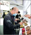  ?? RUAN YANG / FOR CHINA DAILY ?? A visitor checks a chengni ink slab exhibited at the China Internatio­nal Fair for Trade in Services.