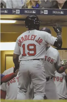  ?? AP PHOTO ?? COMING AROUND: Jackie Bradley Jr. is congratula­ted in the Red Sox dugout after belting a home run during last night’s game against the Brewers in Milwaukee.