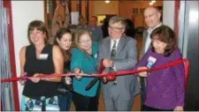  ?? KEVIN TUSTIN — DIGITAL FIRST MEDIA ?? Lansdowne Mayor Tony Campuzano, center, helps cut the ribbon on the new workspace at Utility Works. With Campuzano, from left, are Lansdowne Economic Developmen­t Corporatio­n Executive Director Debbie Brodeur, state Department of Community and Economic...