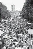  ?? Sean Gallup, Getty Images ?? Thousands of Germans gather at the Victory Column in Berlin’s city center to hear speeches during a protest against coronaviru­s- related restrictio­ns and government policy.