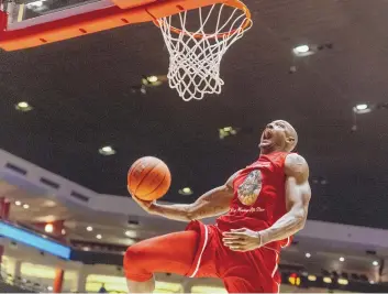  ?? MIKE SANDOVAL/FOR THE JOURNAL ?? Former Lobo J.R. Giddens dunks during the Miranda Sanchez dunk contest he won during Sunday night’s Enchantmen­t alumni all-star basketball game in the Pit.