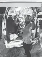  ??  ?? 遭人丟爆竹而受傷的男­球迷，由救護車載去醫院治療。