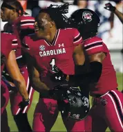  ?? SEAN RAYFORD – THE ASSOCIATED PRESS ?? South Carolina defensive back Jaycee Horn, center, and his teammates celebrate their 30-22 victory over Auburn.