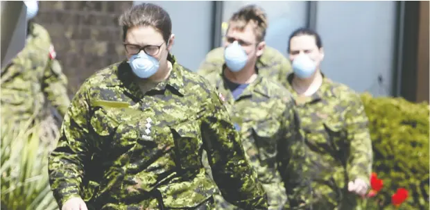  ?? VERONICA HENRI / POSTMEDIA NEWS FILES ?? Members of the Canadian Armed Forces head into Orchard Villa long-term care home in Pickering, Ont., in the first week of May. Now it’s military people with experience in logistics who are overseeing the vaccine rollouts for Canada and Ontario.