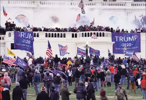  ?? John Minchillo / Associated Press ?? Rioters supporting President Donald Trump, storm the Capitol in Washington on Jan.6. A faction of local, county and state Republican officials across the country is pushing lies, misinforma­tion and conspiracy theories online that echo those that helped inspire the violent Capitol insurrecti­on, forcing the GOP into an internal reckoning.