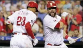  ?? TOM MIHALEK — THE ASSOCIATED PRESS ?? Aaron Altherr, left, and Cameron Rupp celebrate during the fifth when the pair hit back-to-back home runs to put the Phillies on 10-3 win over Atlanta. inning track for