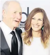  ?? ROBYN BECK/AFP/GETTY IMAGES ?? Jerry Weintraub and actress Julia Roberts arrive for the 17th annual Hollywood Film Awards Gala at the Beverly Hilton Hotel in Beverly Hills in this 2013 file photo.