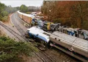  ?? TIM DOMINICK / THE STATE ?? Authoritie­s investigat­e the scene of a fatal Amtrak train crash in Cayce, South Carolina, on Sunday. At least two were killed and dozens injured.