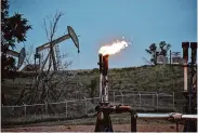  ?? Matthew Brown/Associated Press 2021 ?? A flare burns methane from oil production on a well pad near Watford City, N.D. The Interior Department issued a final rule Friday to raise drilling royalties.