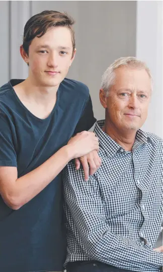  ?? Picture: GLENN HAMPSON ?? Architect Bayden Goddard, who has just been given the all-clear after a battle with throat cancer, with his son Max, 15, at his Isle of Capri home.