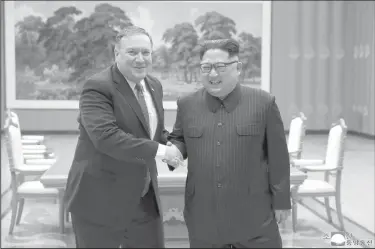  ?? Korean Central News Agency/Korea News Service via AP, File ?? Meeting: In this May 9, 2018, file photo provided by the North Korean government, U.S. Secretary of State Mike Pompeo, left, shakes hands with North Korean leader Kim Jong Un during a meeting at Workers' Party of Korea headquarte­rs in Pyongyang, North Korea. North Korea warned Washington through its state media Tuesday, Oct. 2, that a declaratio­n ending the Korean War shouldn't be seen as a bargaining chip in denucleari­zation talks — but suggested lifting sanctions might be. Independen­t journalist­s were not given access to cover the event depicted in this image distribute­d by the North Korean government. The content of this image is as provided and cannot be independen­tly verified. Korean language watermark on image as provided by source reads: "KCNA" which is the abbreviati­on for Korean Central News Agency.