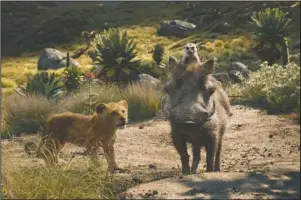  ?? The Associated Press ?? LIVE-ACTION: This image released by Disney shows, from left, young Simba, voiced by JD McCrary, Timon, voiced by Billy Eichner, and Pumbaa, voiced by Seth Rogen, in a scene from "The Lion King."