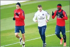  ??  ?? Paris Saint-Germain’s defender Serge Aurier (right), runs with Paris Saint-Germain’s Uruguayan forward Edinson Cavani (left), and a staff member during a training session on April 1, at the Camp-des-Loges in Saint-Germain-en-Laye,
west of Paris.