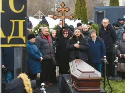  ?? OLGA MALTSEVA/GETTY-AFP ?? Alexei Navalny’s mother and father — Lyudmila Navalnaya, center, and Anatoly Navalny, second from left — mourn Friday at his funeral in Moscow. Music from “The Terminator 2,” a film their son loved, was played during burial.