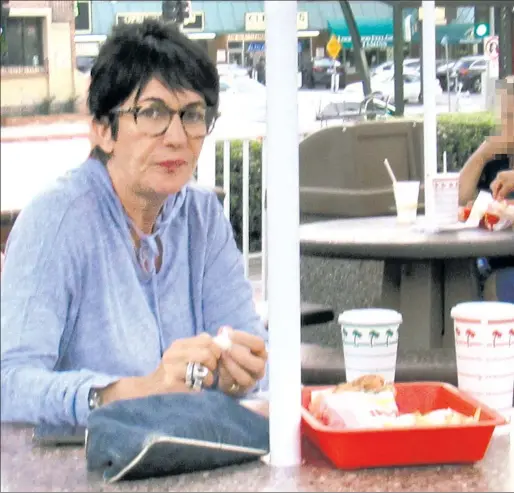  ??  ?? OUT-ED: Ghislaine Maxwell, who has been lying low since she was accused of recruiting girls for Jeffrey Epstein, eats at an In-N-Out Burger in LA.