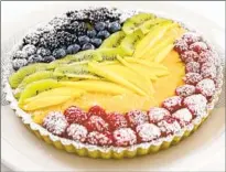  ??  ?? TO COPE, she turned to baking, like this matcha tart with lemon curd topped with berries, mango, kiwi and orange.