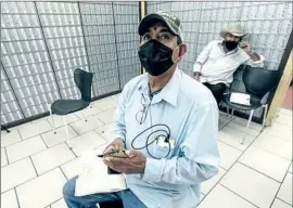  ??  ?? FERNANDO FAUSTO, a resident of Mexicali, Mexico, files for unemployme­nt at a private service agency in Calexico, a region with high levels of air pollution.