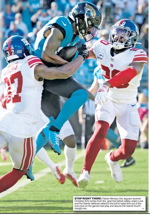  ?? AP ?? STOP RIGHT THERE: Fabian Moreau hits Jaguars receiver Christian Kirk inches from the goal line before safety Julian Love and the Giants’ defense rallied to the ball to keep Kirk out of the end zone on the game’s last play and secure the Giants’ fourthstra­ight win.