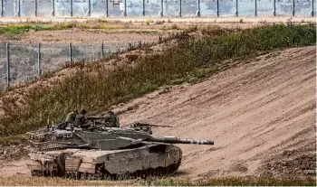  ?? Tsafrir Abayov/associated Press ?? Israeli soldiers rest Monday on their tank on the border with the Gaza Strip.