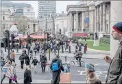  ?? ANDREW TESTA — THE NEW YORK TIMES ?? A Christmas market in Trafalgar Square in London bustles with people on Saturday. Prime Minister Boris Johnson is accelerati­ng Britain’s coronaviru­s vaccine booster program.