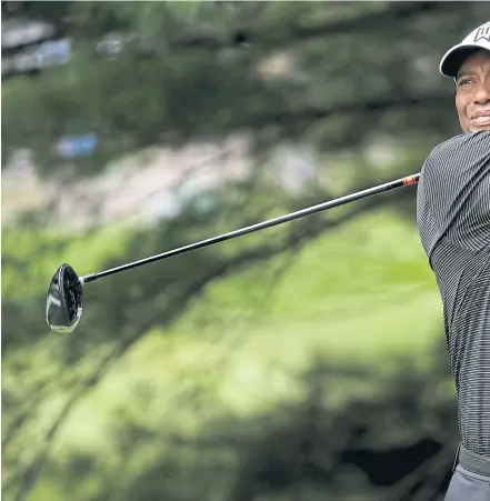  ??  ?? Tiger Woods plays a shot in the second round of the ongoing World Golf Championsh­ips-Bridgeston­e Invitation­al on Friday.