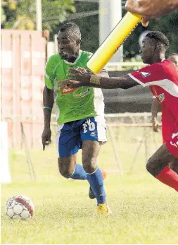  ?? FILE ?? In this file photo from January 2018, Boy’s Town FC’s Shaquille Bradford (right) tries to stop Montego Bay United’s Dwayne Ambusley during a Premier League at the Barbican Sports Complex.