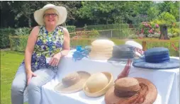  ??  ?? Hospice volunteer Ann Godden Day with a selection of hats on sale at the Ashford Pilgrims Hospice fete