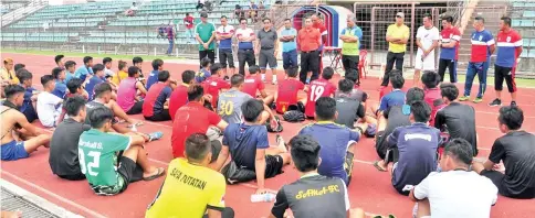  ??  ?? Benedict speaking to the players after the completion of the phase one selection trials at the Likas Stadium, yesterday.