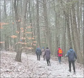  ?? BETSY GRAHAM ?? At the end of the winter season, hikers encounter a snow squall.