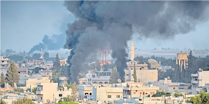  ??  ?? A photo taken from Turkey’s Sanliurfa province shows smoke rising in the city of Ras al-ayn in Syria as Turkish troops along with the Syrian National Army begin Operation Peace Spring in northern Syria against the Syrian Democratic Forces