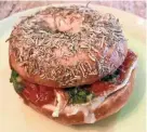  ?? CAROL DEPTOLLA/ MILWAUKEE JOURNAL SENTINEL ?? One of the breakfast bagel sandwiches by Foxfire food truck is tomato, pesto and brie, a combinatio­n that’s in harmony with the rosemary-sea salt bagel by Ruby’s Bagels.