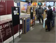  ?? ASSOCIATED PRESS FILE PHOTO ?? Customers debate on a television selection during a Black Friday sale at Best Buy on Nov. 26in Indianapol­is.