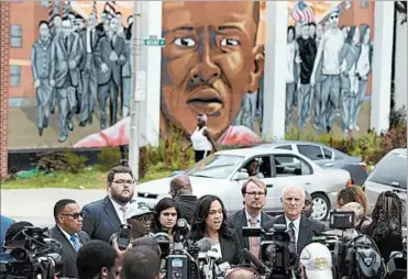  ?? STEVE RUARK/AP ?? Baltimore State’s Attorney Marilyn Mosby, center, meets the media Wednesday after her office dropped all remaining charges against officers involved in the Freddie Gray case. Third from left, in a cap, is Gray’s stepfather, Richard Shipley.