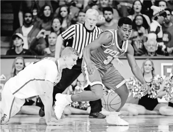  ?? CASEY SAPIO, USA TODAY SPORTS ?? UCLA guard Aaron Holiday, right, had two steals against Arizona in the Bruins’ 77-72 victory Saturday.