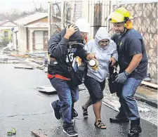 ??  ?? Rescue workers come to the rescue after Hurricane Maria