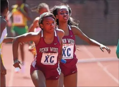  ?? PETE BANNAN — DIGITAL FIRST MEDIA ?? Penn Wood teammates Janae Pitt, left, and Kyra Carroll helped the Patriots finish fifth in the Championsh­ip of America 4 x 800 at the Penn Relays in April.