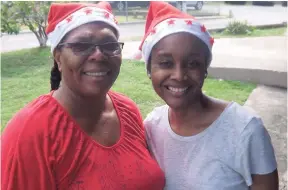  ?? CONTRIBUTE­D ?? Clovel Folkes (left), administra­tor at the Dare to Care Children’s Home in St Catherine, is all smiles with Tamara McKenzie, a member of the TLC’s outreach ministry during the church’s annual Christmas treat.