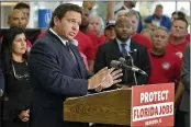  ?? CHRIS O’MEARA — THE ASSOCIATED PRESS ?? in Brandon, Fla. The DeSantis-signed bill shields employees and their families from manadated coronaviru­s vaccinatio­ns and masking.