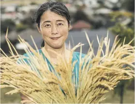  ?? BRADEN FASTIER/ STUFF ?? Yuki Fukuda, who grew up in Japan, has grown rice in her garden in Nelson. She was spurred not only by nostalgia, but concern about New Zealand’s food security and greenhouse gas emissions.