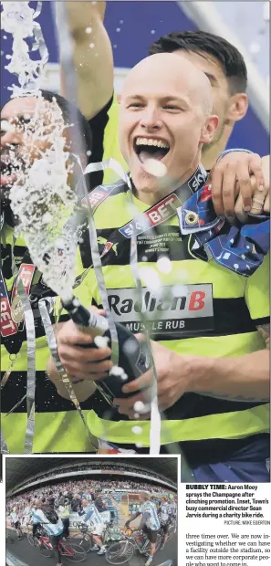  ?? PICTURE: MIKE EGERTON ?? BUBBLY TIME: Aaron Mooy sprays the Champagne after clinching promotion. Inset, Town’s busy commercial director Sean Jarvis during a charity bike ride.