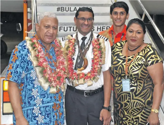  ?? Photo: Waisea Nasokia ?? Prime Minister Voreqe Bainimaram­a with Fiji Airways Captain Satpreet Singh, wife Sharmila Singh, son Prashant Preet Singh (standing at back) Hangar, Naisoso, Nadi. at the Fiji Airways