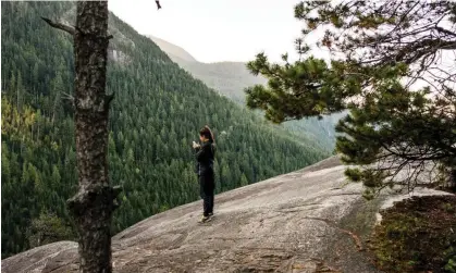  ?? Rosanna U/Getty Images/Image Source ?? A visitor enjoys the scenery around Squamish, British Columbia, Canada. The new initiative aims to avoid unwanted discoverie­s among the area’s trails and crags. Photograph: