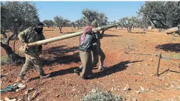  ?? GHAITH ALSAYED THE ASSOCIATED PRESS ?? Rebel fighters prepare to fire a missile towards Syrian government positions in the province of Idlib on Sunday. Nearly 600,000 people have fled the fighting.