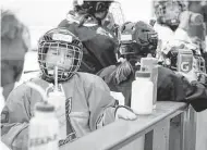  ??  ?? Hallie Kimbell makes sure to properly hydrate during Sunday’s workout at the Houston Girls Hockey Associatio­n’s registrati­on event in the Aerodrome.