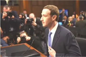 ??  ?? Zuckerberg waits for a Senate committee hearing to begin.