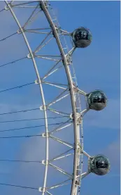  ?? ?? Top: A stately arrival at Kew: the Elizabeth Gate to London’s Royal Botanic Gardens. Above left: Mayor Anne Hidalgo with The Queen in her eponymous Parisian flower market. Above right: One of the London Eye pods bears the name Coronation Capsule