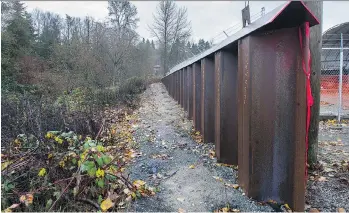  ?? JASON PAYNE ?? Constructe­d metal dikes are shown along Bolivar Creek in Surrey. In 2015, a study of Lower Mainland dikes found that none of them meet current provincial standards.