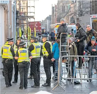  ??  ?? Police and members of the media wait for Salmond’s arrival at the court.